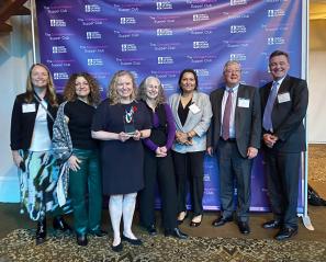 A group of people in a awards giving celebration event