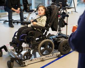 A child sitting on a computerized wheelchair