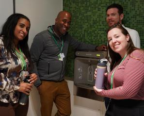 Four people are trying the new water machine