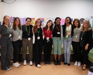 A group of people standing and having a photo together