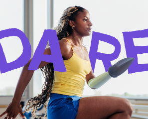 A young woman who uses a prosthetic arm running inside a gym