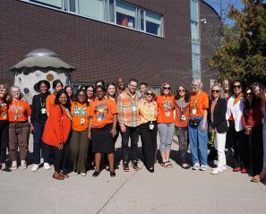 Group of people in an outdoor setting wearing orange