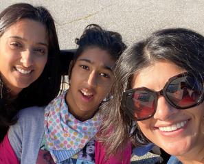 Teen girl and two women smile