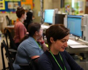 A nurse works alongside colleagues at a nursing station in the inpatient unit at Holland Bloorview Kids Rehabilitation Hospital.