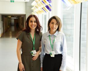 Two people standing by the hallway