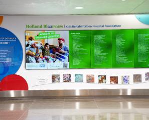 A colourful digital display featuring names of various donors