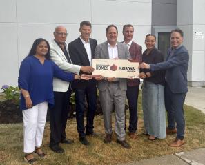 group of adults holding a sign during an announcement