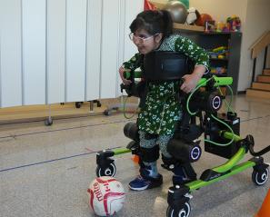 A child using the Trexo to move around a room