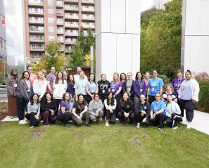 A big group of people having a group photo in an outdoor setting