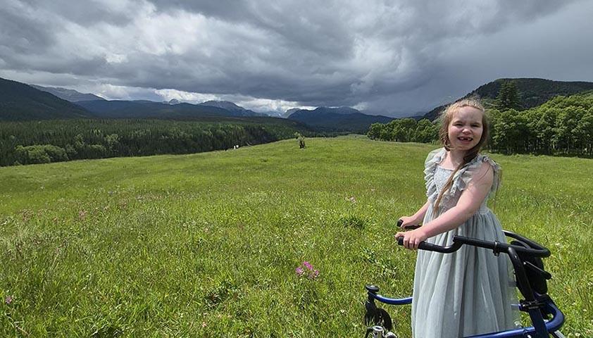 A girl with walker in an outdoor setting