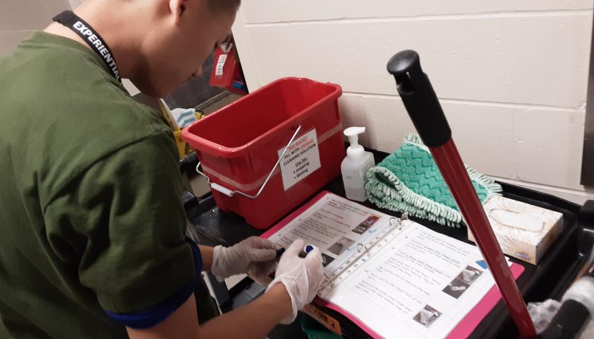 One of the Project SEARCH students checking his checklist.