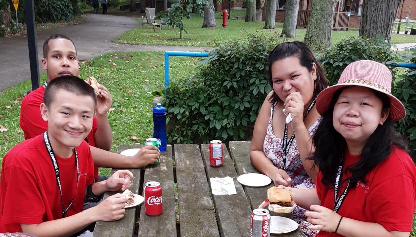 Project SEARCH students sitting on a picnic table.