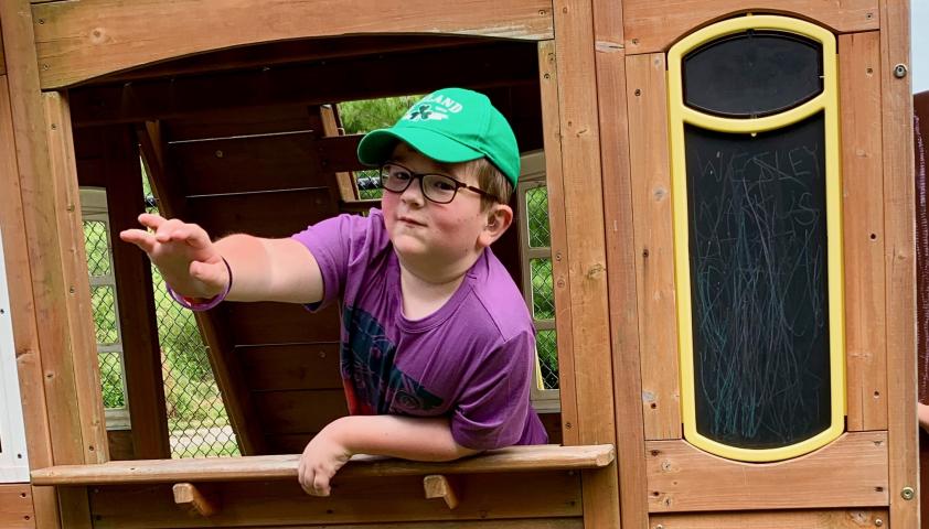 Wesley playing in his "restaurant' in the backyard. 