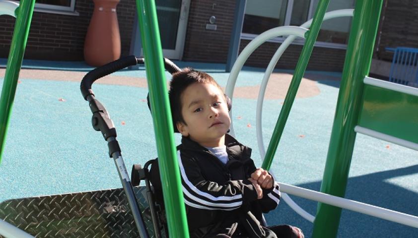 Bloorview School Authority student playing in wheel chair swing