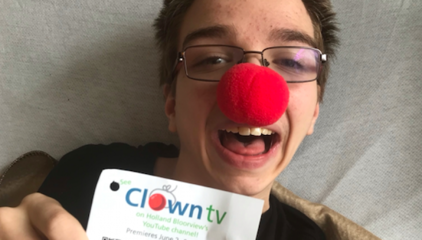 Andrew wearing a red nose smiling at the camera. 