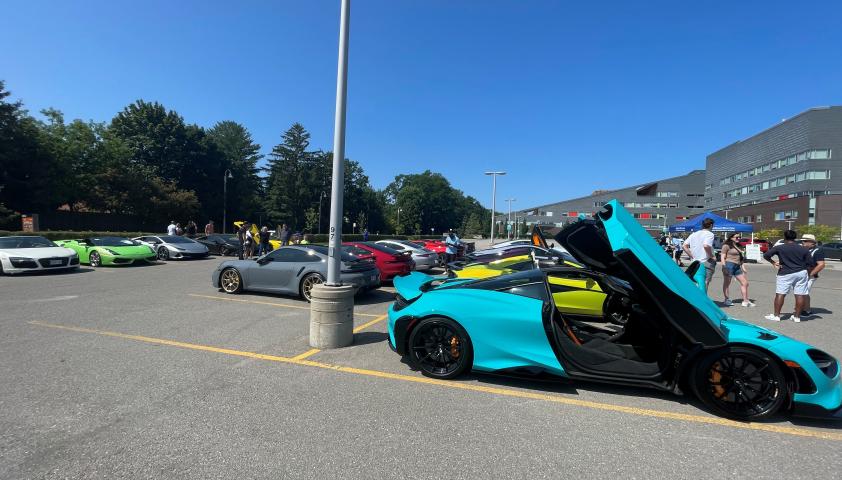 Blue exotic car with door open.