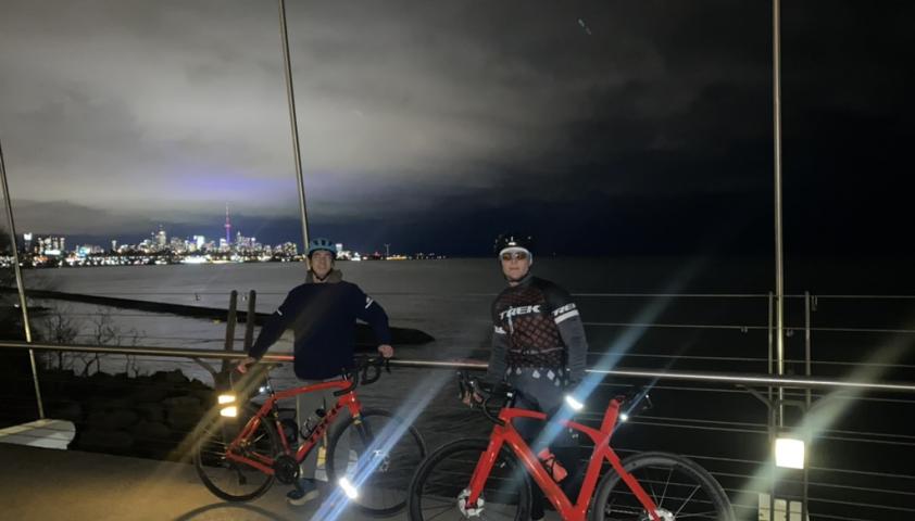 Xavier and another person with his bike on a bridge at night