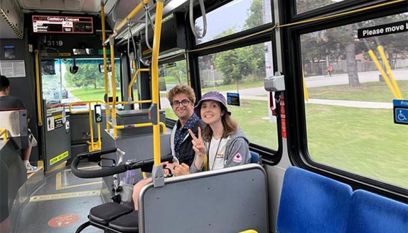 Two teenagers are riding a transit