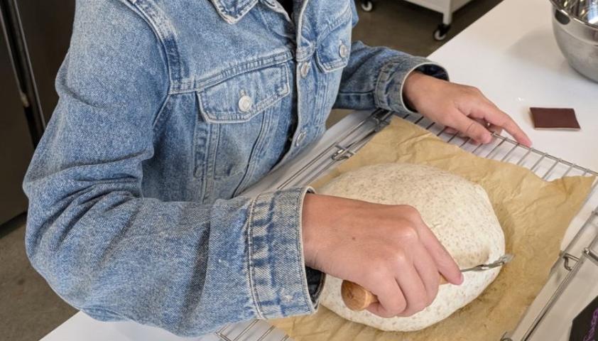 Annie baking bread, cropped photo of her hands forming the bread