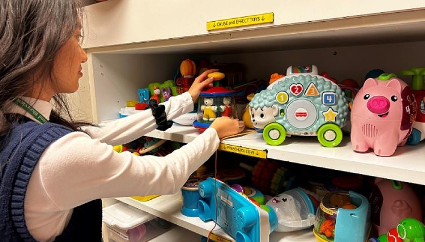 Extern Denica Yeo organizing toys on shelf