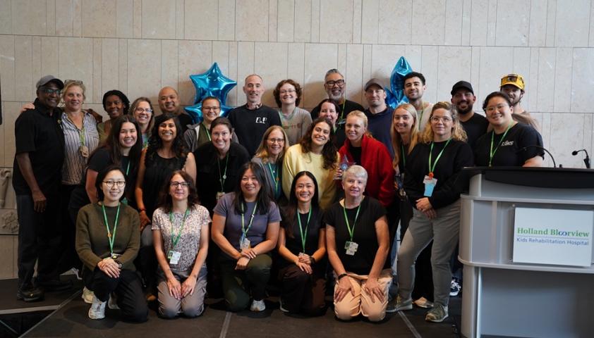 group of people in atrium posing for a photo 