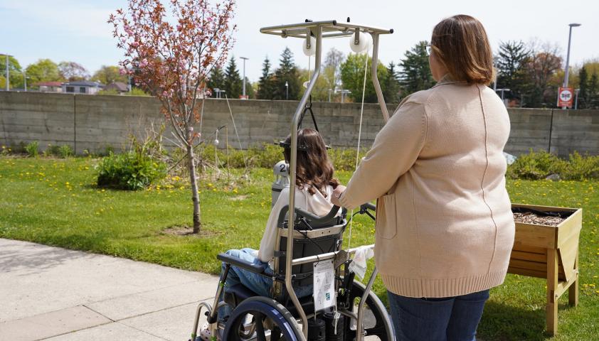 Teen and her mom enjoying the sunshine in a garden