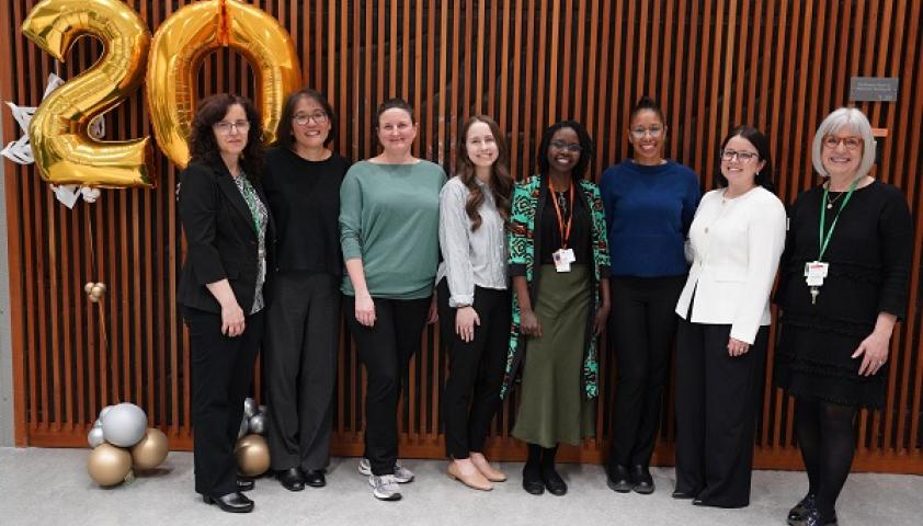 group of adults standing in room