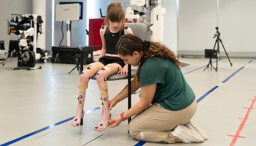 patient sitting on chair with clinician in Motion Analysis Centre lab