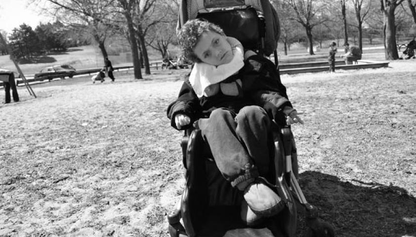 Black and white photo of Owen sitting in his chair