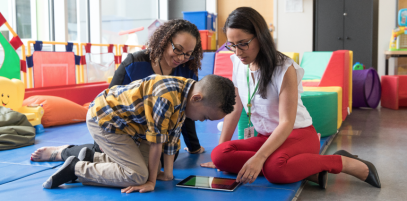 Two adults playing with a kid