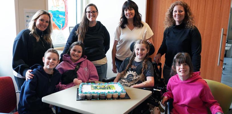 Holland Bloorview mothers Jenny, Jessica, Melissa and Allyson stand behind their daughters and inpatient clients Hannah, XX, Finnley and Scarlett who met during their time at the hospital. 