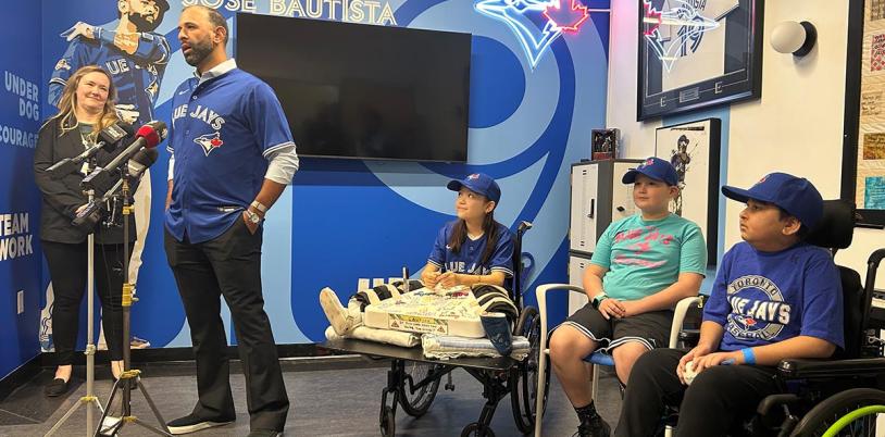 A group of people in an indoor setting, with some Blue Jays logos