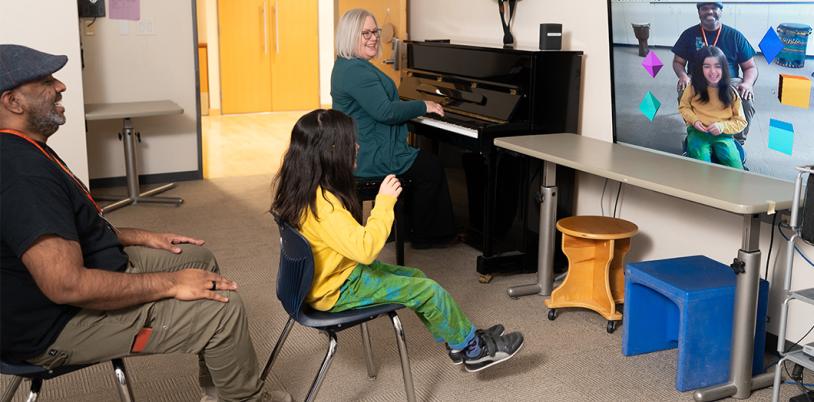 A child plays music using a virtual music instrument