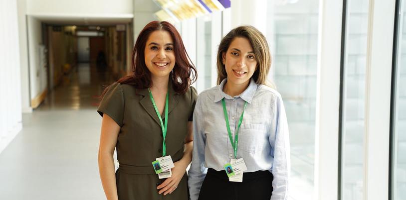 Two people standing by the hallway