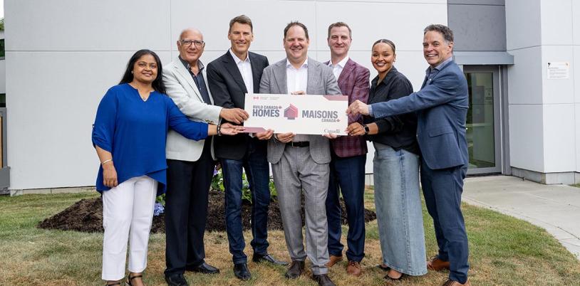 group of adults holding a sign during an announcement