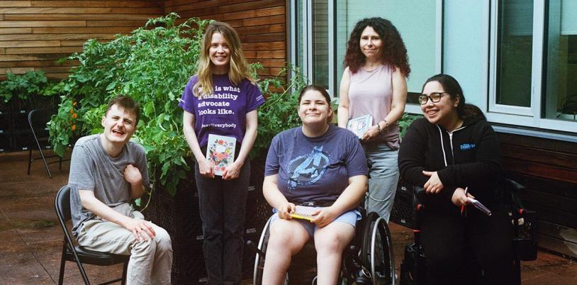 Five adults in an outdoor setting for a group photo