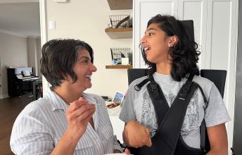 Woman feeds teen girl who uses wheelchair