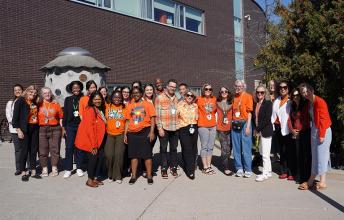Group of people in an outdoor setting wearing orange