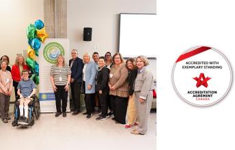 A group of people on the left, Accreditation Canada badge on the right