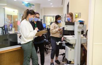 Some hospital staffs working in front of a station