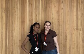 Two female students standing and posing for a photo