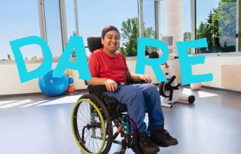 A teenager on a wheelchair, with the word "DARE"