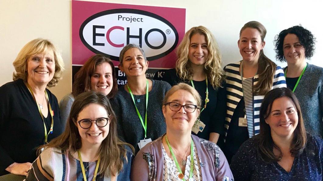 A group of woman in front of a sign that says Project ECHO