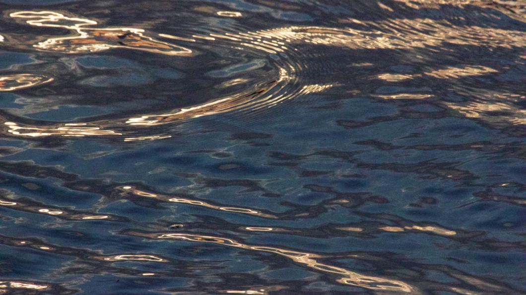 Photo of sunset reflected in waves