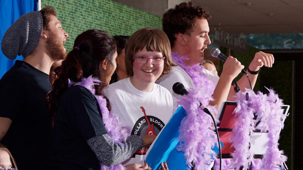 Youth singing at microphones