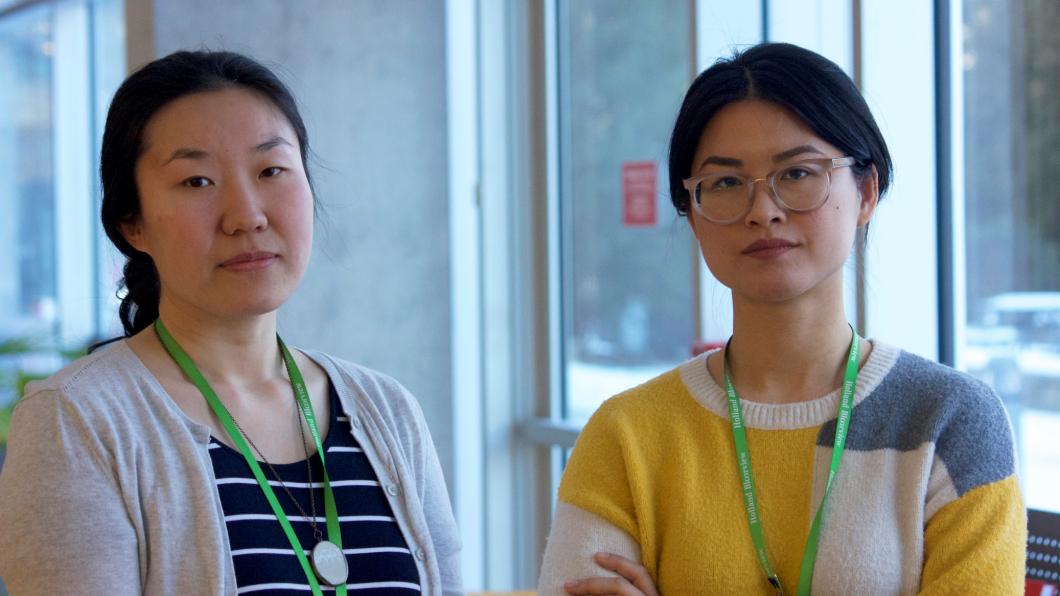 Two Asian hospital staff members