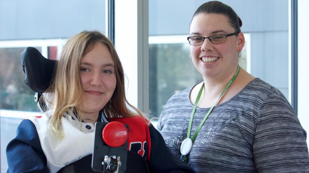 Nurse with young woman in wheelchair