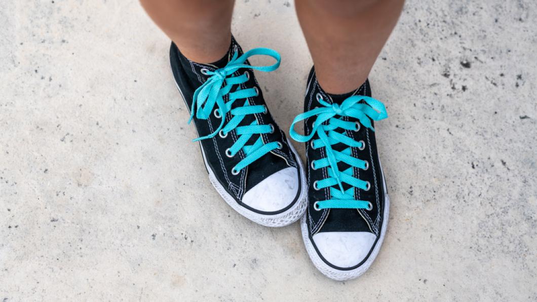 Picture of child's feet wearing converse running shoes