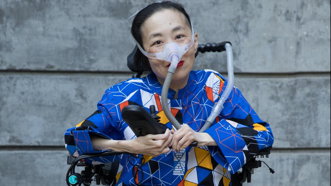 Photo of an Asian American woman in a power chair