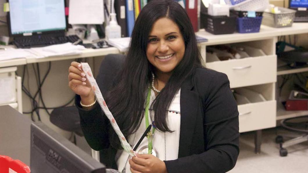 Woman holding medication strip in pharmacy